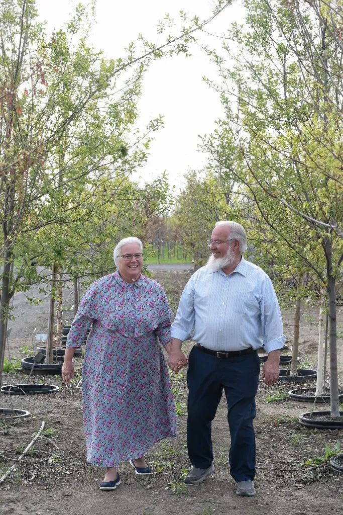 Everett and Sandra walking hand in hand through the nursery